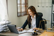 © Nuttapong punna - Beautiful asian woman lawyer working and gavel, tablet, laptop in front, Advice justice and law concept...