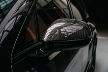 A Close-up On A Car Exterior Mirror Made From Carbon Fiber Of Interwoven Black And Gray Color