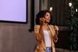 © bnenin - African businesswoman giving a speech, standing in the conference hall.