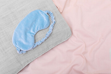 Poster - Light blue sleep mask on beige cloth, top view. Space for text