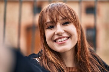 Sticker - Young woman smiling confident making selfie by the camera at street