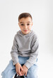 © Zhuravleva Katia - Boy child preschooler smiling and posing on gray background in photo studio