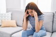 © Krakenimages.com - Young hispanic girl stressed sitting on sofa at home