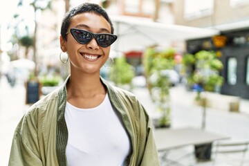 Sticker - Young hispanic woman smiling confident standing at street