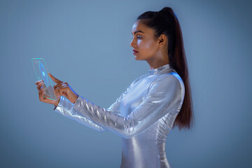 A woman wearing silver futuristic  clothes holding digital tablet, A future technology concept