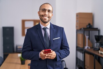 Sticker - Young latin man business worker smiling confident using smartphone at office