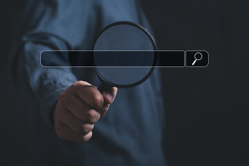 Wall Mural - hand holding magnifying glass. searching for information. using search console with your website. da