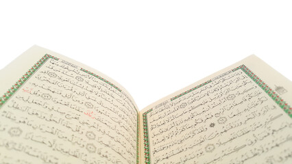 Open Quran pages with white background. Surah Al Baqarah. Arabic letters. Selective focus on letters. Al-Quran is a holy book of Islamic guidance isolated. Religion concept.