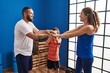 © Krakenimages.com - Family smiling confident with hands together at sport center