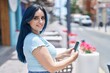 © Krakenimages.com - Young caucasian woman smiling confident using smartphone at street