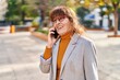 © Krakenimages.com - Middle age woman business executive talking on the smartphone at park