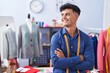 © Krakenimages.com - Young hispanic man tailor smiling confident standing with arms crossed gesture at clothing factory