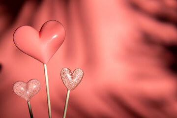 Wall Mural - three Pink Valentine's day heart shape lollipop candy on empty pastel paper background. Love Concept