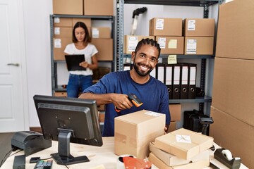 Canvas Print - Man and woman business partners scanning package using barcode reader at storehouse