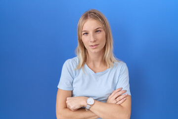 Canvas Print - Young caucasian woman wearing casual blue t shirt looking sleepy and tired, exhausted for fatigue and hangover, lazy eyes in the morning.