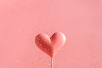 Wall Mural - Pink Valentine's day heart shape lollipop candy on empty pastel paper background. Love Concept