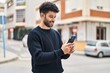 © Krakenimages.com - Young arab man smiling confident using smartphone at street