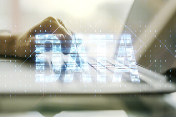 Wall Mural - creative data word hologram and hands typing on computer keyboard on background, big data and blockc