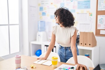 Canvas Print - Young middle eastern woman business worker smiling confident standing by desk at office