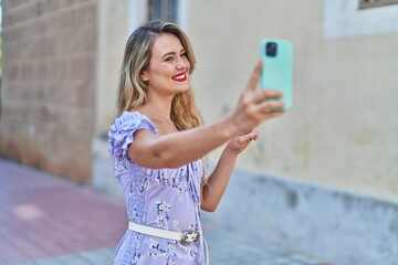 Sticker - Young beautiful hispanic woman smiling confident making selfie by the smartphone at street