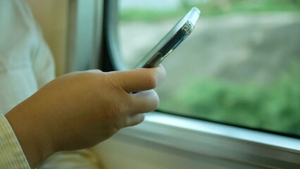 Canvas Print - A man in a commuter train subway metro traveling and uses the smartphone happy tourist travel by train  Freedom trip on vacation time holiday weekend