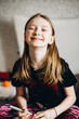© Анна Молько - happy smiling girl in white t-shirt is drawing at home