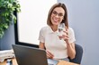 © Krakenimages.com - Young beautiful hispanic woman business worker using laptop drinking water at office