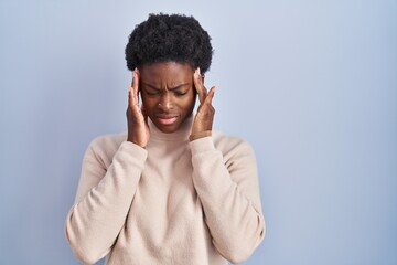 Wall Mural - African american woman standing over blue background with hand on head for pain in head because stress. suffering migraine.