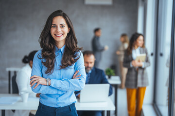 shot of a confident young businesswoman standing in a modern office. portrait of a businesswoman sta