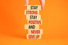 Never Give Up Symbol. Concept Words Stay Strong Stay Positive Never Give Up On Wooden Blocks. Beautiful Orange Background. Copy Space. Businessman Hand. Motivational Business Never Give Up Concept.