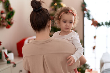 Poster - Woman and toddler standing by christmas tree at home