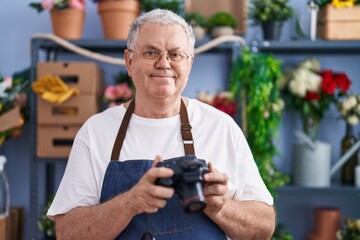 Poster - Middle age grey-haired man florist make photo to bouquet of flowers gift at florist