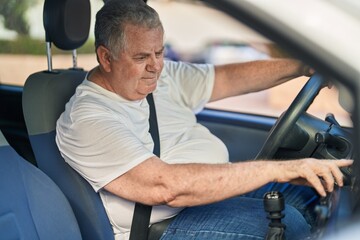 Canvas Print - Middle age grey-haired man smiling confident driving car at street