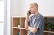 © Krakenimages.com - Young caucasian man talking on the smartphone standing at home