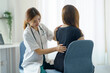 © amnaj - Physical therapist takes care of a patient with back pain at a clinic.