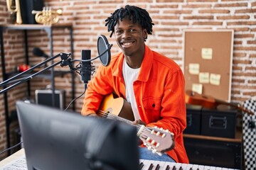 Poster - African american man singing song playing classical guitar at music studio