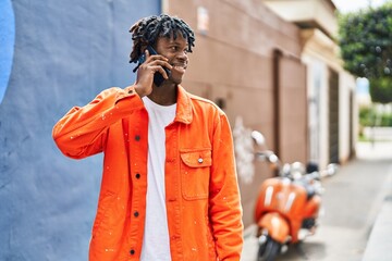 Sticker - African american man smiling confident talking on the smartphone at street