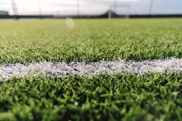 Close-up of mini soccer field lines. Background soccer pitch grass football stadium ground view. Ground football field grass macro