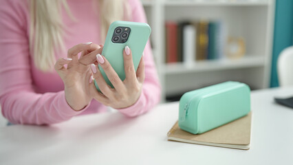 Sticker - Young blonde woman student using smartphone sitting on table at library university