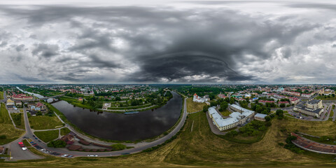 Wall Mural - aerial seamless spherical 360 hdri panorama overlooking old town, historic buildings with bridge across wide river with dark sky with storm black clouds in equirectangular projection. vr ar content