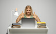© Volodymyr_sh - Cheerful office worker business student woman freelancer showing two thumbs up in front of laptop while speaking with a partners or clients.