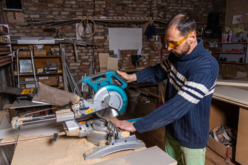 A carpenter works in a furniture workshop