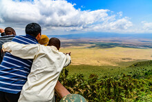 View Of The Ngorongoro Crater In Tanzania. Ngorongoro Conservation Area. African Landscape. Guide Showing Something To Tourists