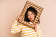 Young african american woman holding a vintage frame isolated