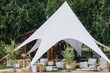 © Oleksii Syrotkin/Stocksy - Wedding ceremony tent garden event