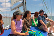 © Tessy Morelli/Stocksy - Diverse group boat travel