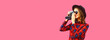 © rohappy - Portrait of happy smiling young woman photographer with film camera on pink background, blank copy space for advertising text