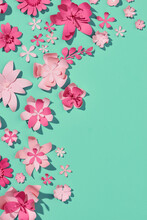 Dark Pink And Pink Paper Flowers On The Green Background