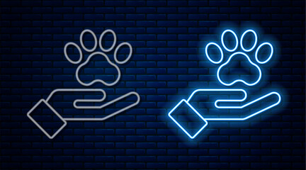 Sticker - Glowing neon line Hands with animals footprint icon isolated on brick wall background. Pet paw in heart. Love to the animals. Vector