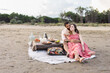 © Studio Serra/Stocksy - Couple Cuddling During Dinner At The Beach